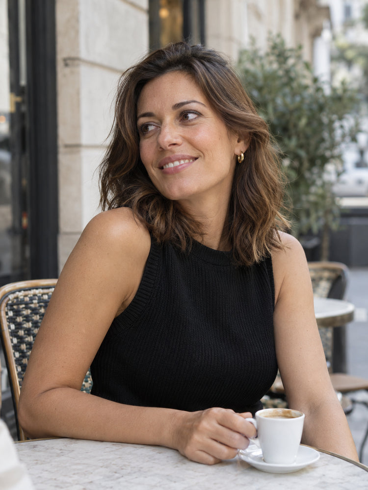 A brunette woman enjoying a quiet cafe morning